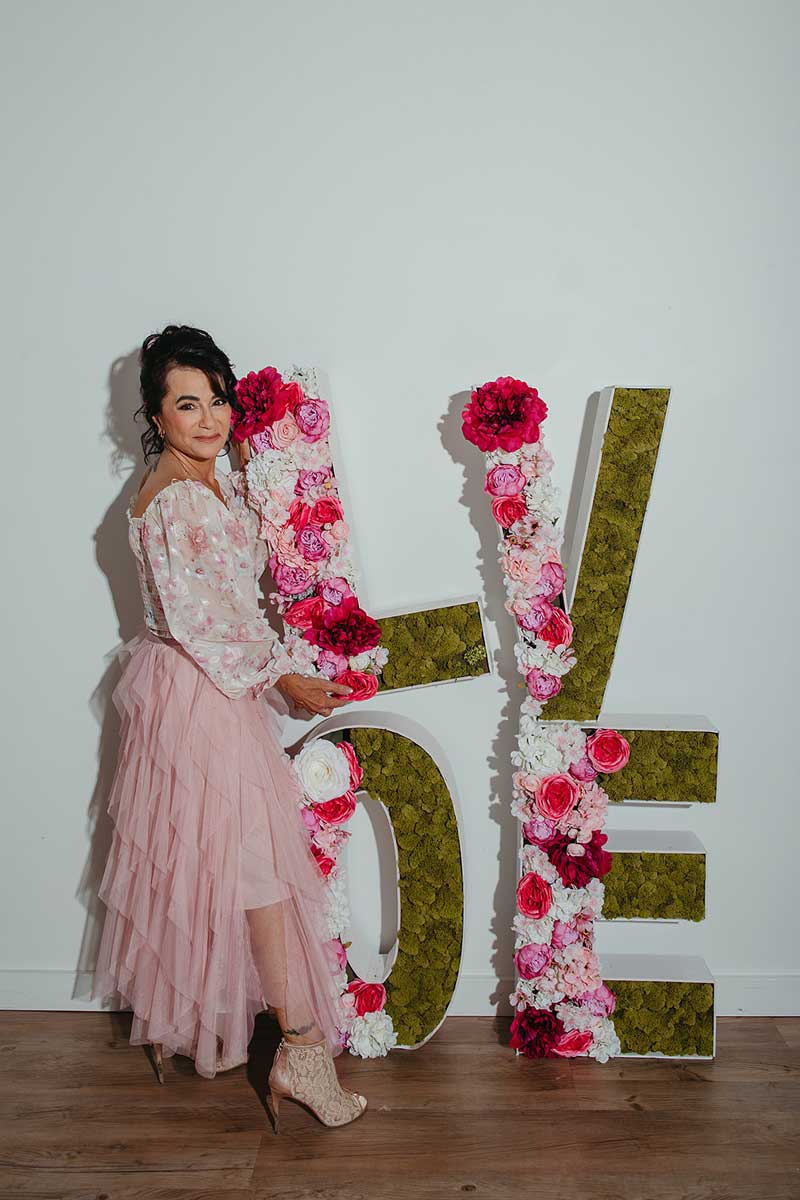 Pamela with "LOVE" sign