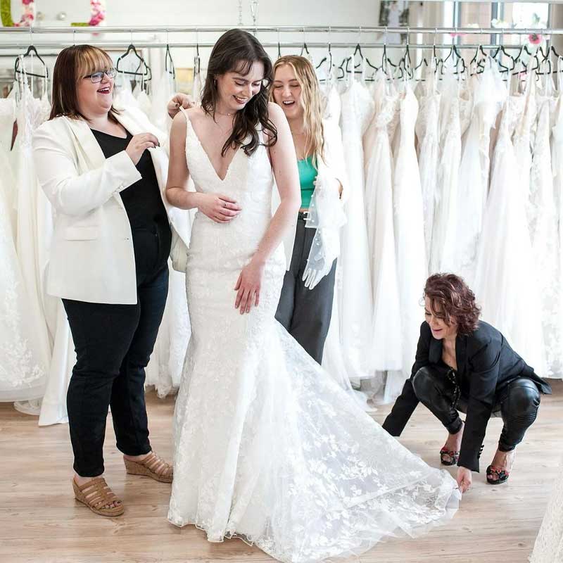 Novia Mia team helping a bride-to-be with her wedding dress