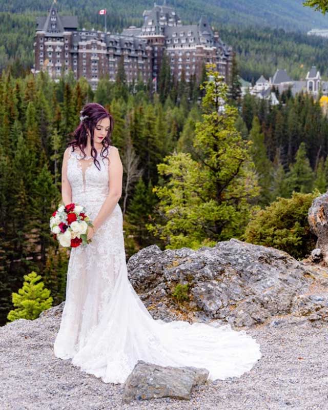Destiny Johnston with her wedding dress on Lake Louise