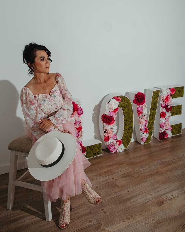 Pamela sitting beside the "LOVE" sign Pamela sitting beside the "LOVE" sign